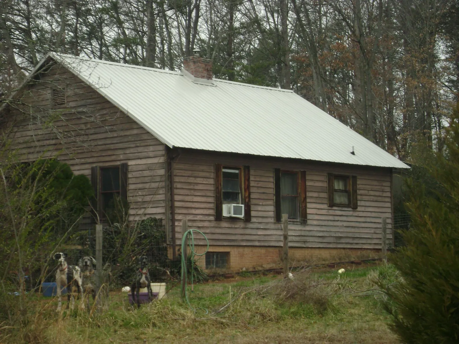White metal roof on an old wood sided farmhouse in Conway